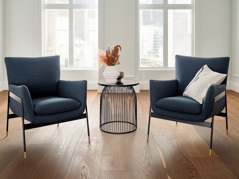 two blue armchairs on a brown hardwood floor from BOOTH FLOORING INC in Tolland, CT